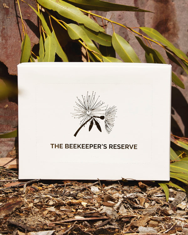 White gift box with 'The Beekeeper's Reserve' logo on a natural background - includes 6 honey varieties