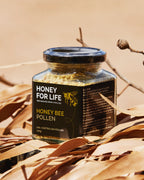 Jar of honey bee pollen with 'Honey for Life' label on a natural background