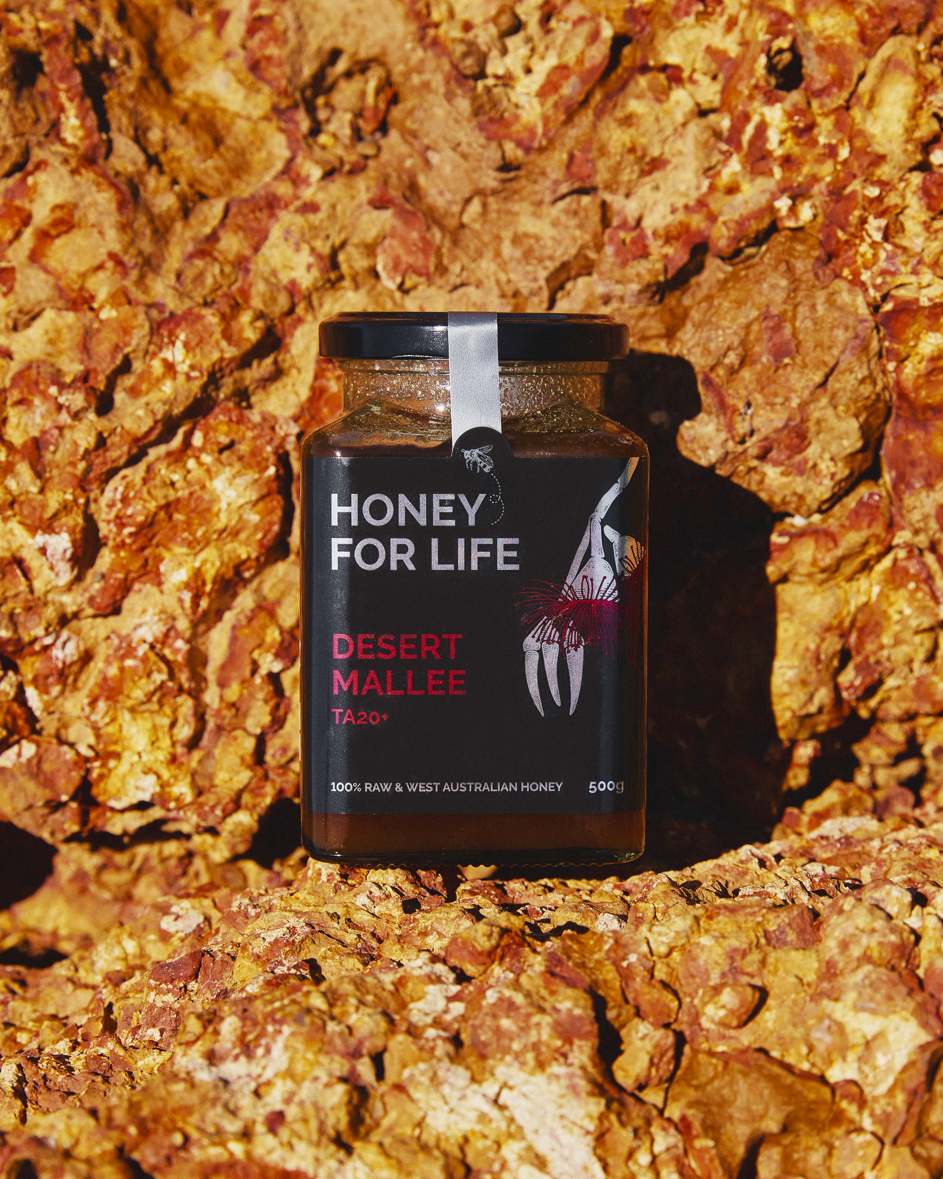 Jar of Honey for Life Desert Mallee honey on a rocky background