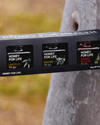 Packaging of 'Honey for Life' honey with tree in the background