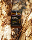 Jar of 'Honey for Life' jarrah honey against a tree bark background