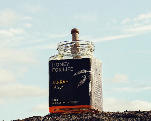 Jar of honey with a label against a natural background